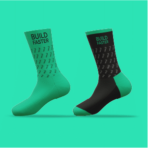 A pair of green socks that have 'build faster' written on them